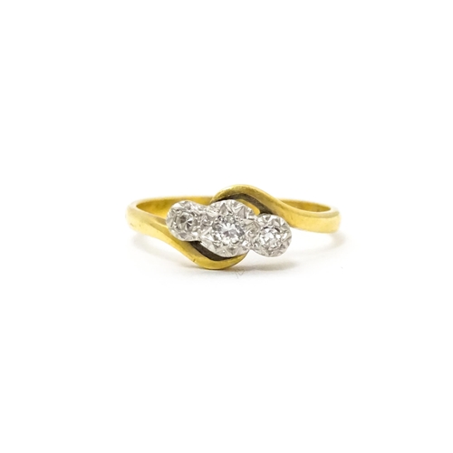 628 - An 18ct gold ring with platinum set diamond trio. Ring size approx. N