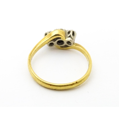 628 - An 18ct gold ring with platinum set diamond trio. Ring size approx. N