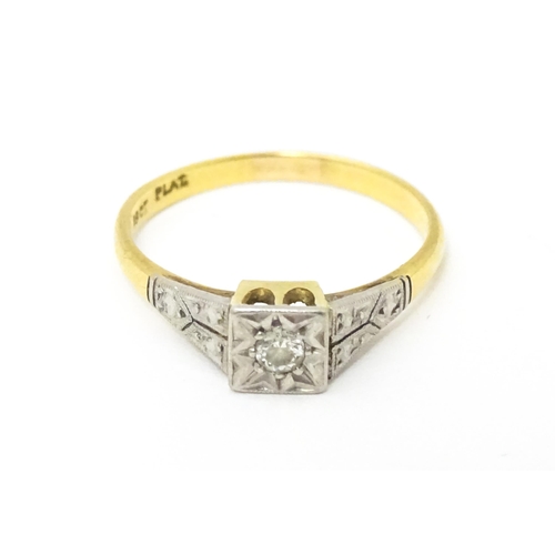 629 - An 18ct gold ring with platinum set diamond. Ring size approx. P