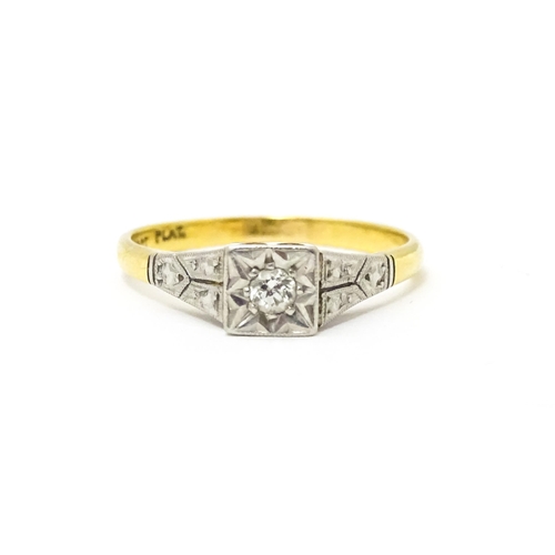 629 - An 18ct gold ring with platinum set diamond. Ring size approx. P