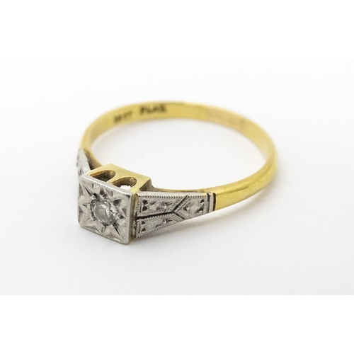 629 - An 18ct gold ring with platinum set diamond. Ring size approx. P