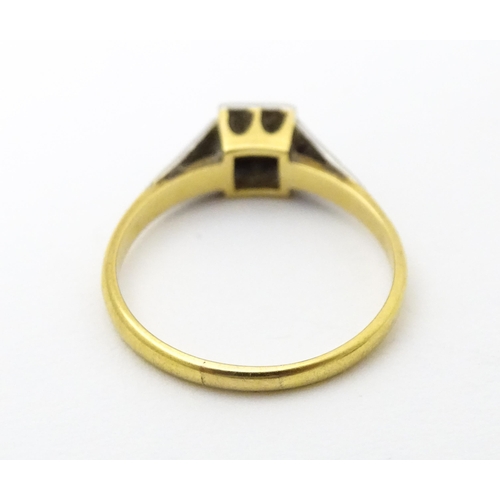 629 - An 18ct gold ring with platinum set diamond. Ring size approx. P