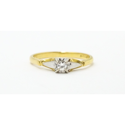 630 - An 18ct gold ring set with central diamond solitaire. Ring size approx. T