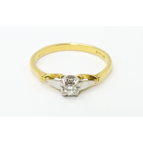 630 - An 18ct gold ring set with central diamond solitaire. Ring size approx. T