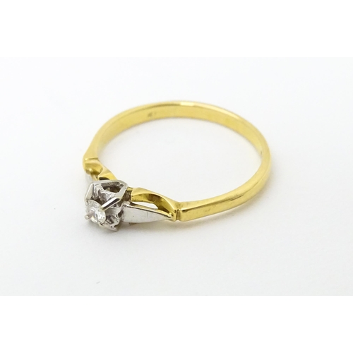 630 - An 18ct gold ring set with central diamond solitaire. Ring size approx. T