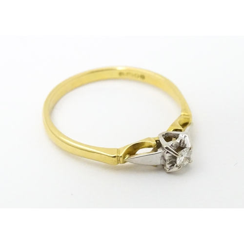 630 - An 18ct gold ring set with central diamond solitaire. Ring size approx. T