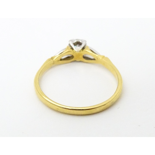 630 - An 18ct gold ring set with central diamond solitaire. Ring size approx. T