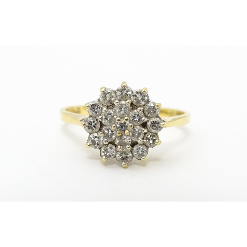 631 - An 18ct gold ring set with diamond cluster. Ring size approx. J 1/2