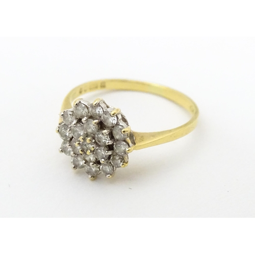 631 - An 18ct gold ring set with diamond cluster. Ring size approx. J 1/2