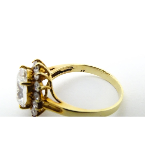 632 - A yellow metal ring set with white stones. Ring size approx. N