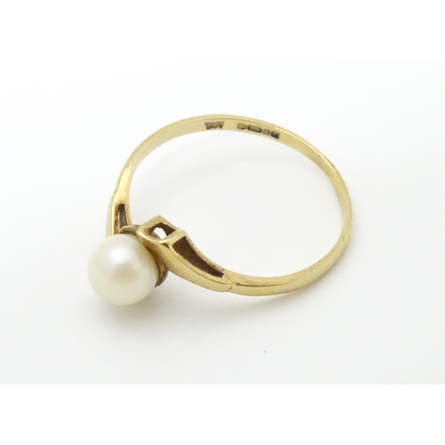 633 - A 9ct gold ring set with single pearl. Rings size approx. S 1/2