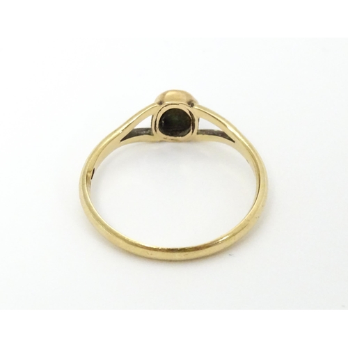 637 - A 9ct gold ring set with turquoise cabochon. Ring size approx. Q 1/2