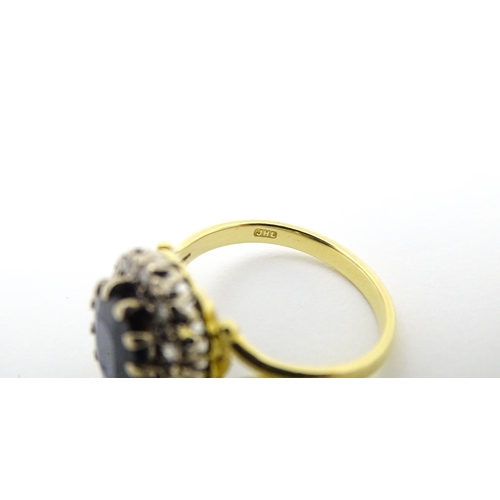 640 - An 18ct gold ring set with central sapphire bordered by diamonds. Ring size approx. L 1/2