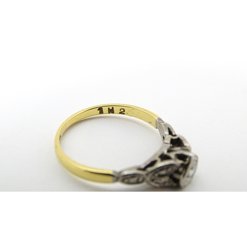 649 - An 18ct gold ring with platinum set central diamond in heart shaped setting. Ring size approx. J. To... 