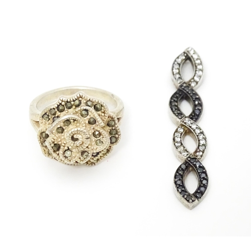 654 - A silver ring set with marcasite detail. Together with a silver pendant. Pendant approx. 2