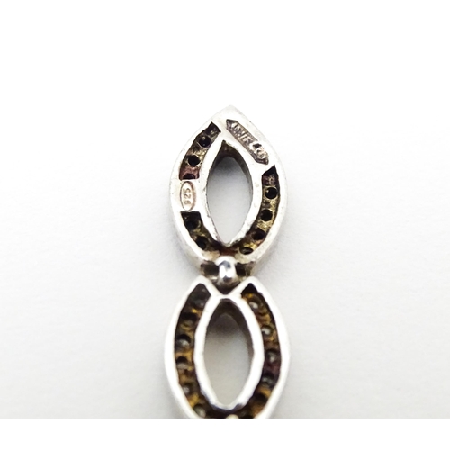 654 - A silver ring set with marcasite detail. Together with a silver pendant. Pendant approx. 2