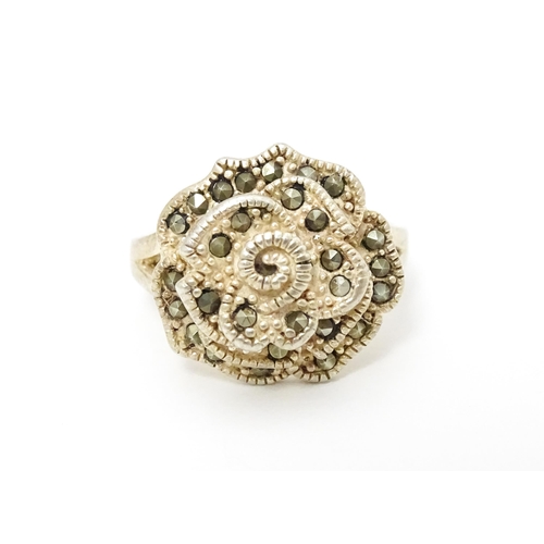 654 - A silver ring set with marcasite detail. Together with a silver pendant. Pendant approx. 2