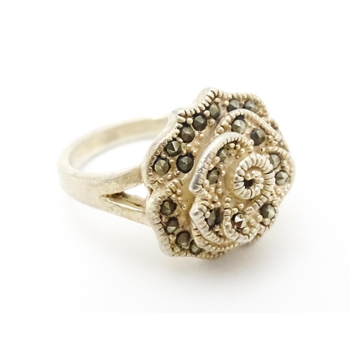 654 - A silver ring set with marcasite detail. Together with a silver pendant. Pendant approx. 2