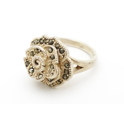 654 - A silver ring set with marcasite detail. Together with a silver pendant. Pendant approx. 2