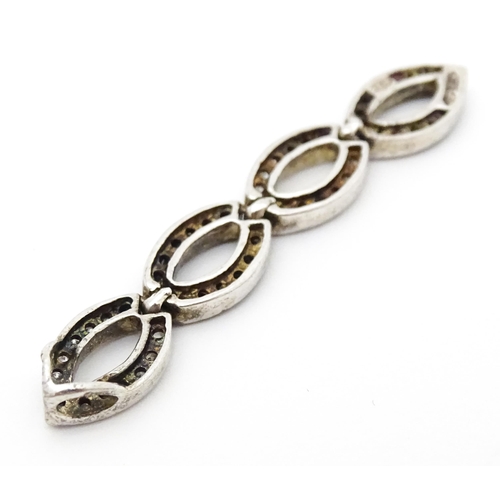 654 - A silver ring set with marcasite detail. Together with a silver pendant. Pendant approx. 2