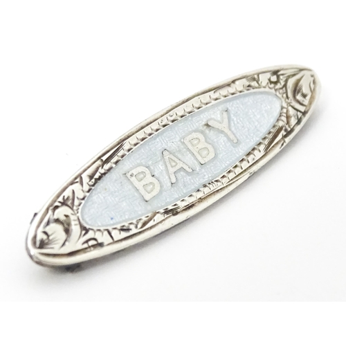 660 - A silver brooch with guilloche enamel decoration titled Baby, marked A.J.C. Sterling. Approx. 1 1/2