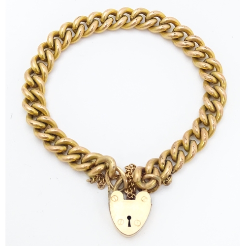 661 - A gold plated bracelet by Pioneer with patent no. 137868, with heart shaped padlock clasp.