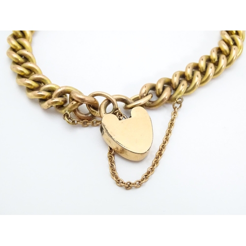 661 - A gold plated bracelet by Pioneer with patent no. 137868, with heart shaped padlock clasp.