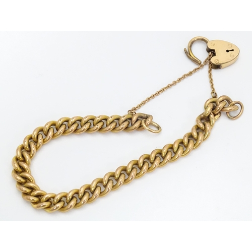 661 - A gold plated bracelet by Pioneer with patent no. 137868, with heart shaped padlock clasp.