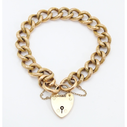 663 - A yellow metal bracelet with 9ct gold clasp of padlock form.