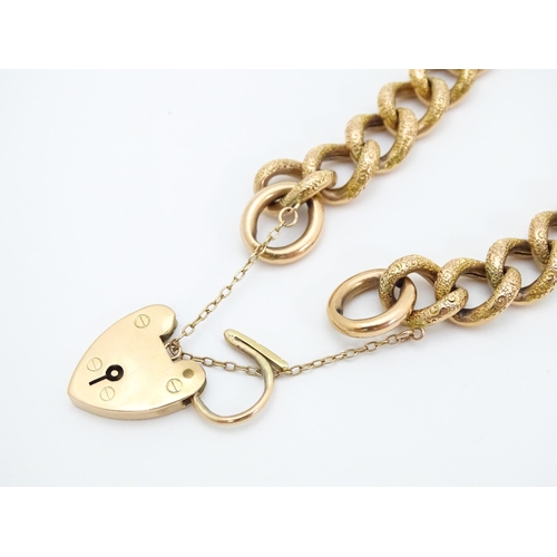 663 - A yellow metal bracelet with 9ct gold clasp of padlock form.