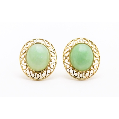 665 - A pair of 9ct gold earrings set with jade coloured cabochon. Approx. 1/2