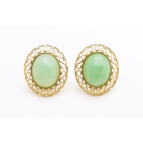 665 - A pair of 9ct gold earrings set with jade coloured cabochon. Approx. 1/2