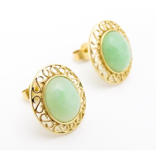 665 - A pair of 9ct gold earrings set with jade coloured cabochon. Approx. 1/2