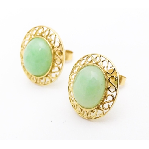 665 - A pair of 9ct gold earrings set with jade coloured cabochon. Approx. 1/2