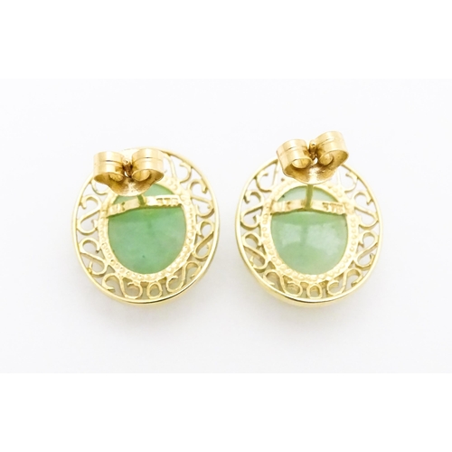 665 - A pair of 9ct gold earrings set with jade coloured cabochon. Approx. 1/2