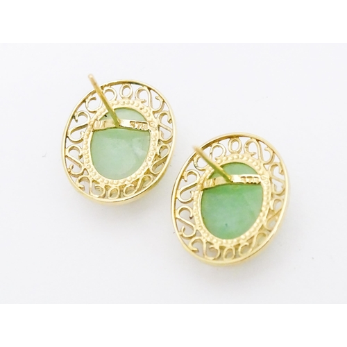 665 - A pair of 9ct gold earrings set with jade coloured cabochon. Approx. 1/2