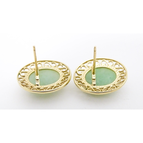 665 - A pair of 9ct gold earrings set with jade coloured cabochon. Approx. 1/2