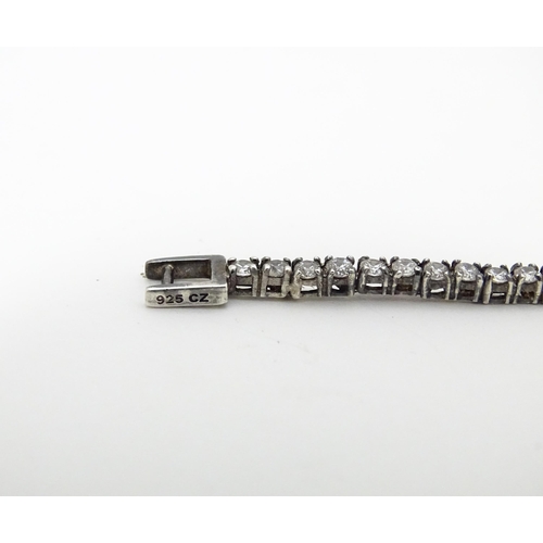 667 - A silver tennis bracelet set with cubic zirconia. Approx. 7