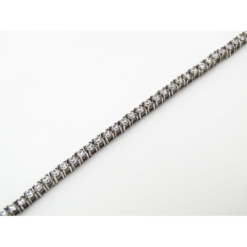 667 - A silver tennis bracelet set with cubic zirconia. Approx. 7