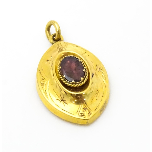 679 - A 19thC yellow metal brooch set with central garnets. Together with a matching pendant and a single ... 