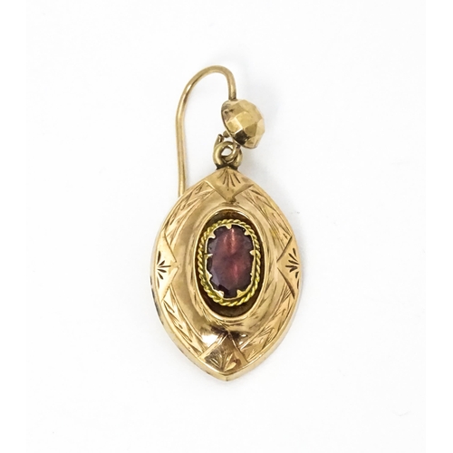 679 - A 19thC yellow metal brooch set with central garnets. Together with a matching pendant and a single ... 