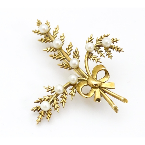 681 - A 9ct gold brooch of foliate form with seed pearl and bow decoration. Approx. 2