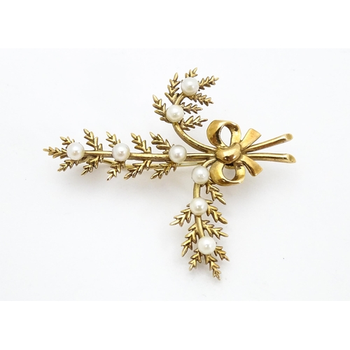 681 - A 9ct gold brooch of foliate form with seed pearl and bow decoration. Approx. 2