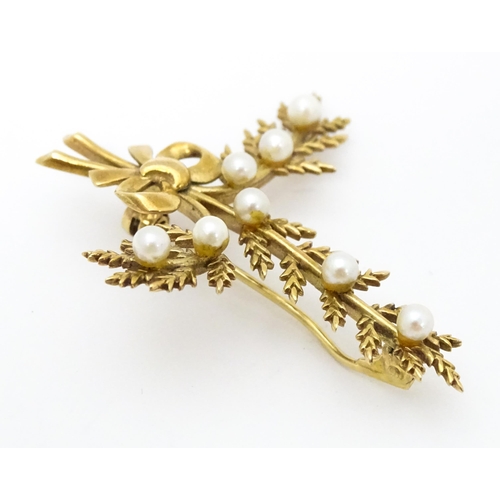 681 - A 9ct gold brooch of foliate form with seed pearl and bow decoration. Approx. 2