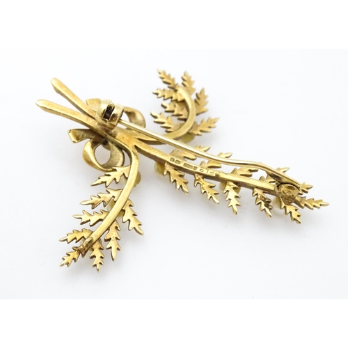 681 - A 9ct gold brooch of foliate form with seed pearl and bow decoration. Approx. 2