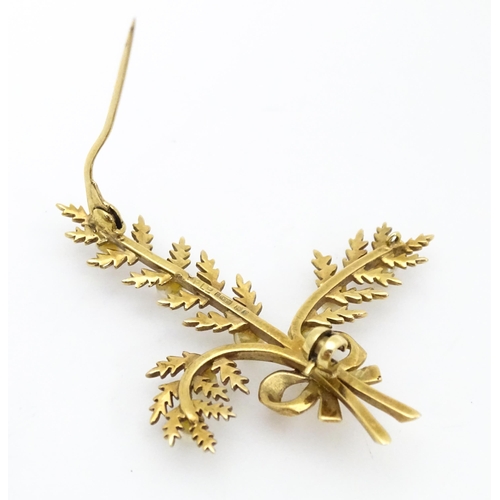 681 - A 9ct gold brooch of foliate form with seed pearl and bow decoration. Approx. 2