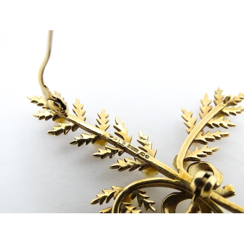 681 - A 9ct gold brooch of foliate form with seed pearl and bow decoration. Approx. 2