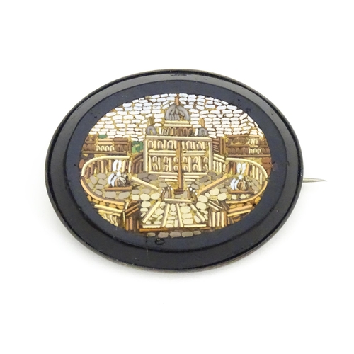 682 - A 19thC Grand Tour brooch with micro mosaic decoration depicting St Peter's Basilica. Approx. 1 3/4