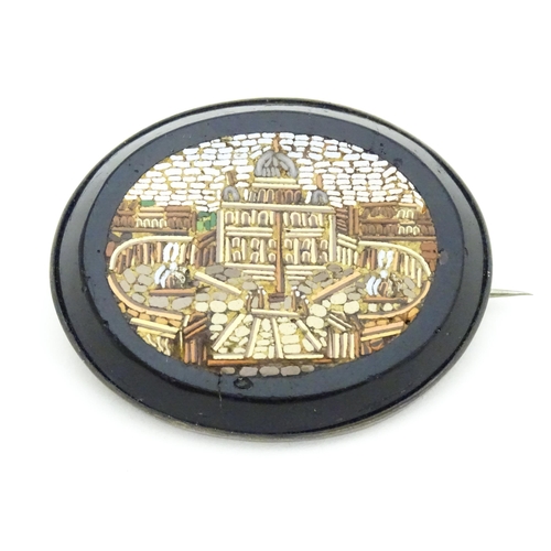 682 - A 19thC Grand Tour brooch with micro mosaic decoration depicting St Peter's Basilica. Approx. 1 3/4