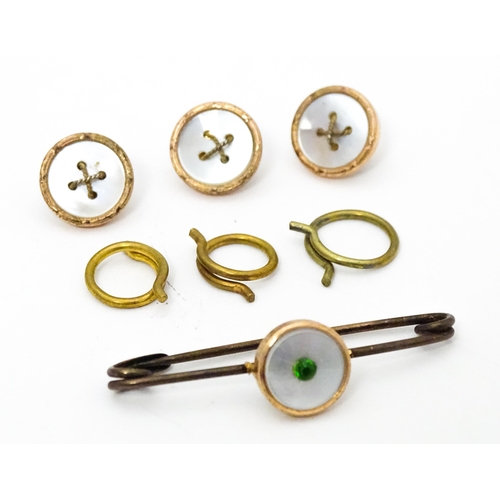 684 - Cased gilt metal studs and pin with mother of pearl detail.